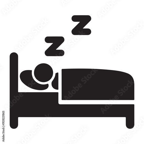This black and white icon depicts a stylized person sleeping in a bed. The figure, represented as a silhouette, lies under a blanket with a headboard visible. Above the person's head.