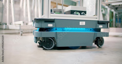 Autonomous mobile robot carrying goods in modern industrial warehouse