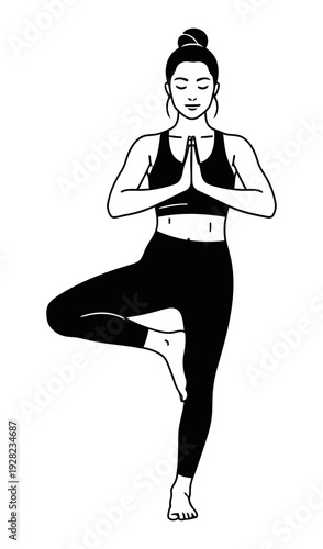 Silhouette of a woman performing the vrikshasana yoga pose demonstrating balance and spiritual focus against a dark background perfect for wellness concepts