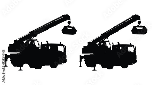 Two construction cranes with wrecking balls in stark black silhouette