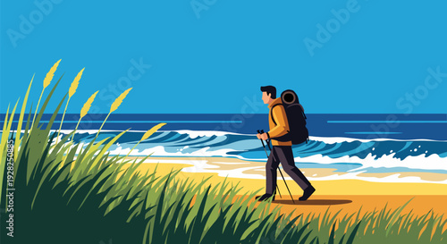 Man with backpack walking along sandy beach beside ocean waves on a sunny day from a grassy viewpoint