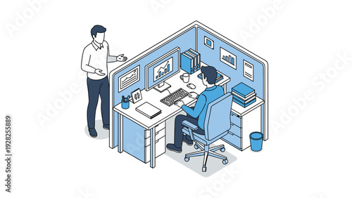 Professional man working at a computer desk within an office cubicle while another man stands and gestures beside him.