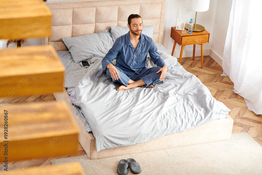 Fototapeta premium Meditative moments at home with a handsome man enjoying tranquility and relaxation in the morning