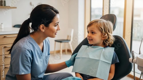 Pediatric dentist talking to young child in modern dental office  