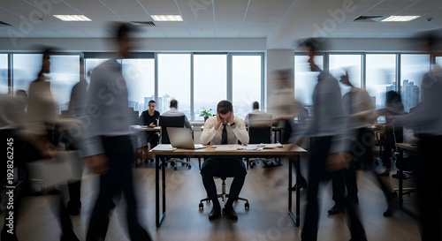Employee surrounded by blurred colleagues moving quickly stillness and overwhelm emphasized open office space