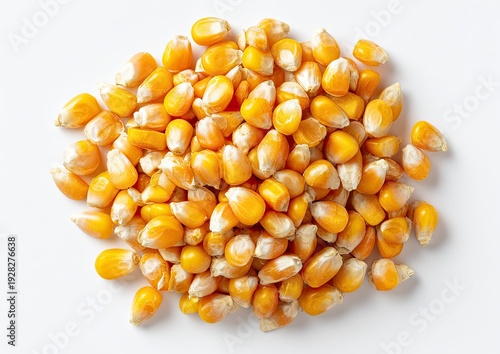Pile of uncooked golden maize kernels, top-down shot on a white background