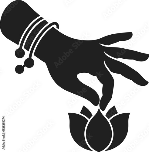 Black silhouette of a hand adorned with bangles gently touching a blooming lotus flower