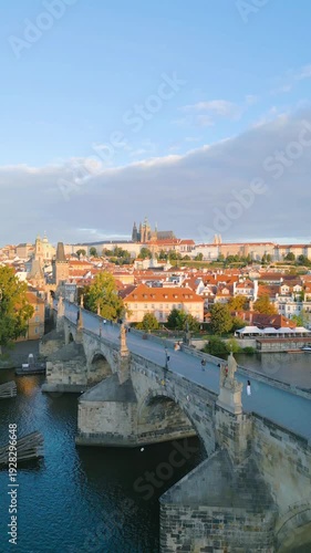 Discover the beauty of Charles Bridge as it stretches over the Vltava River, with stunning views of Prague Castle and the city skyline bathed in morning light.