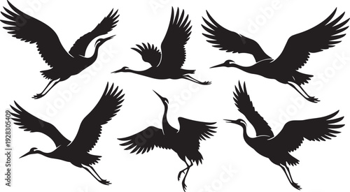 A group of black birds in flight against a white background