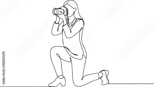 Photographer capturing a moment while kneeling down with a camera