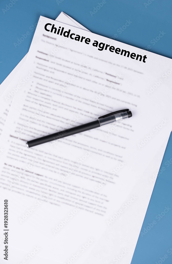 Obraz premium Childcare agreement contract on desk, legal document about child care services, parental responsibilities, and family support concept.