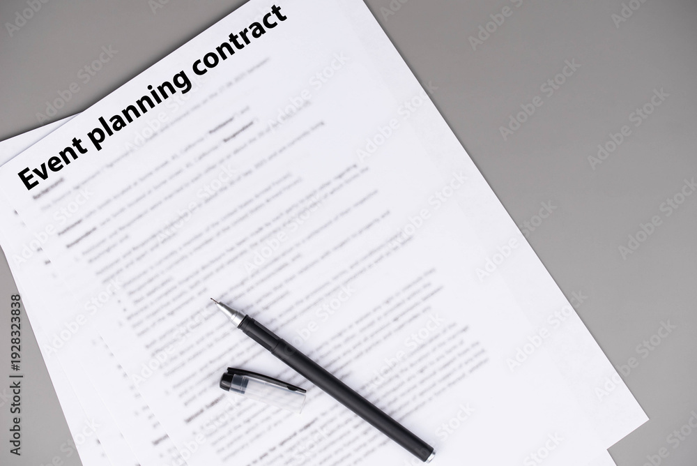 Obraz premium Event planning contract on desk, professional agreement for organizing celebrations and corporate events, symbol of cooperation, creativity, and business partnership.