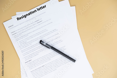 Resignation letter on office desk, formal document where employee voluntarily leaves job, symbol of professional change, career transition, and emotional decision at workplace.