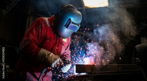 Wallpaper Mural A welder working on a metal structure in a workshop Torontodigital.ca