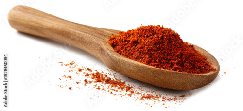 A wooden spoon with red powder on it