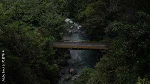 Wallpaper Mural Aerial of road bridge above Rio Celeste river in Costa Rica jungle on rainy day Torontodigital.ca