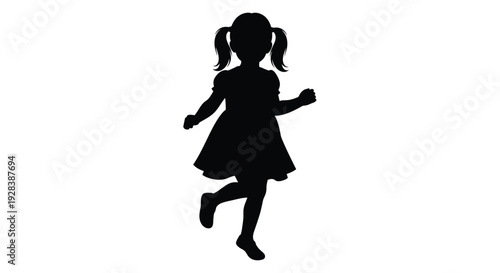 A playful young girl with pigtails in a dark silhouette