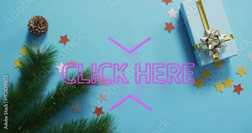 Displaying neon CLICK HERE sign with chevrons glowing on blue surface, with gift box, pinecone