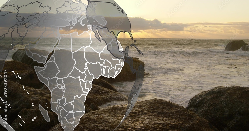 Fototapeta premium Showing faint globe overlay with Africa hovering left over coast at sunset, wet rocks, choppy waves