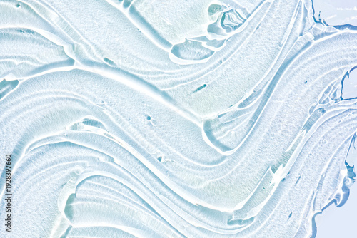 Liquid blue gel cosmetic smudge blue with sun reflects. Beauty product sample swatch