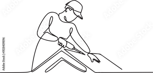 A person is cutting a piece of material with scissors in a workshop from a top viewpoint