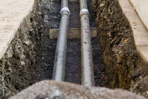 Fotografie Underground pipe installation in a deep excavation trench in Oslo Norway