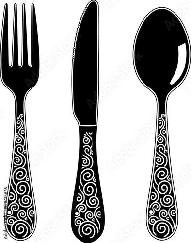 Elegant silverware set with ornate handles and plain white background