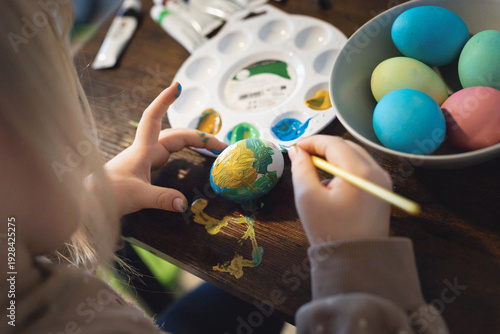 Girl painting easter eggs