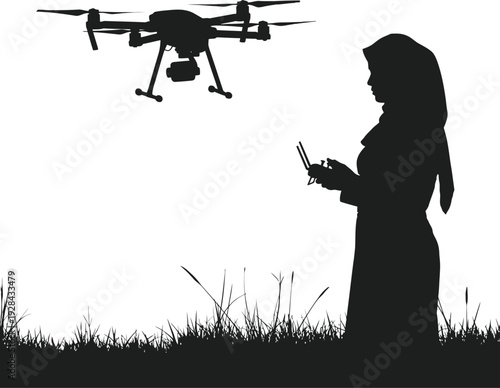 Woman operating a drone with a remote control in a field