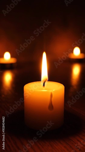 Wallpaper Mural A hand extinguishing a candle flame with other candles burning in the background on a wooden table Torontodigital.ca