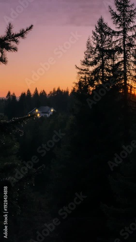 Wallpaper Mural A serene forest landscape at sunset with a house in the distance, trees silhouetted against a vibrant orange and pink sky Torontodigital.ca