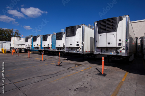Canvastavla parked refrigerated semi truck trailers in cold storage warehouse