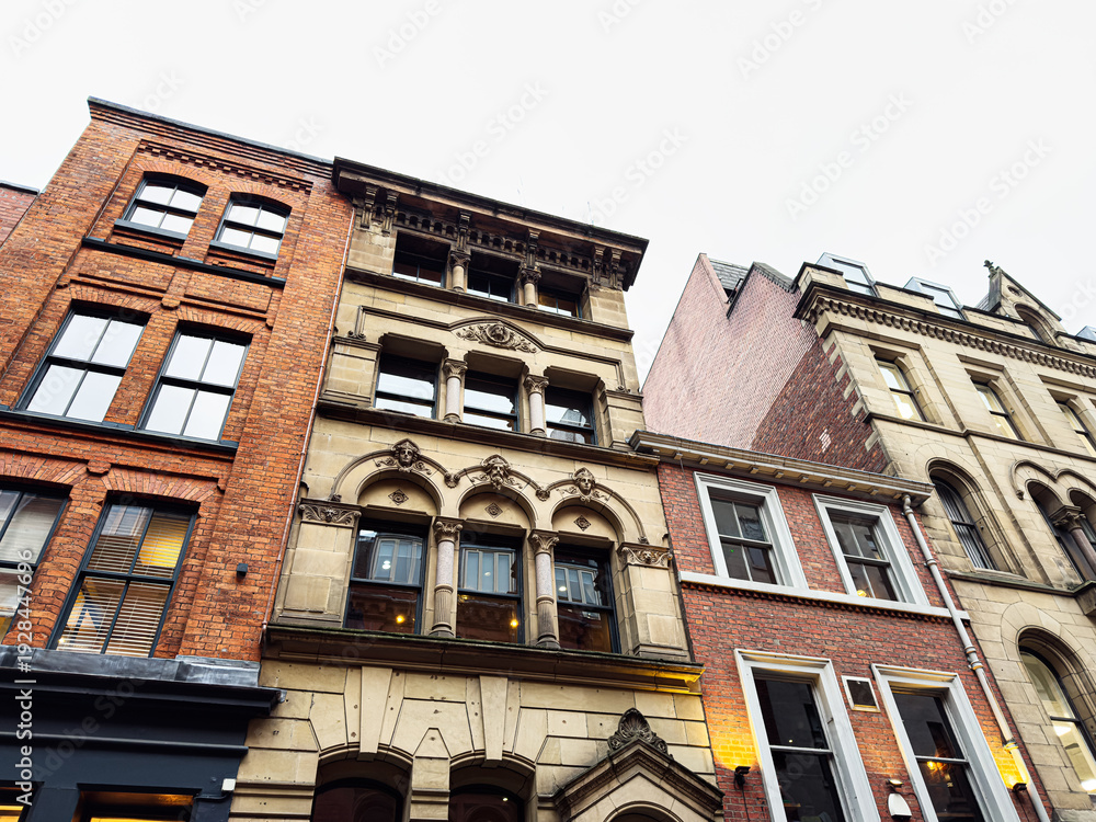 Obraz premium Historic brick and stone city houses in Manchester showcasing architectural details and urban charm