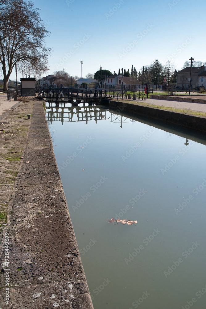 Fototapeta premium The image shows the Fonseranes Locks (Écluses de Fonseranes), a spectacular “water staircase” located on the Canal du Midi in Béziers, France. It was designated a UNESCO World Heritage Site in 1996.