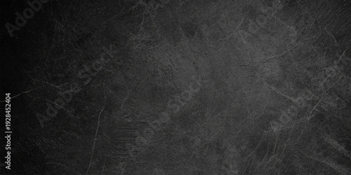 A vintage dark grunge wall featuring a black leather texture and gray concrete surface design for a textured old paper backdrop