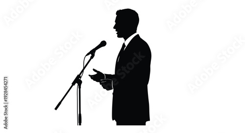 Silhouette of a man in a suit gesturing while speaking at a podium