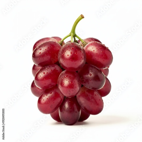 A compact bunch of dark red grapes glistens with moisture while suspended on its stem above a bright white surface.