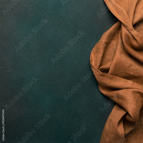 Dark green textured background with brown linen napkin, low key food mockup, flat lay, rustic minimal copy space for menu, recipe, restaurant branding
