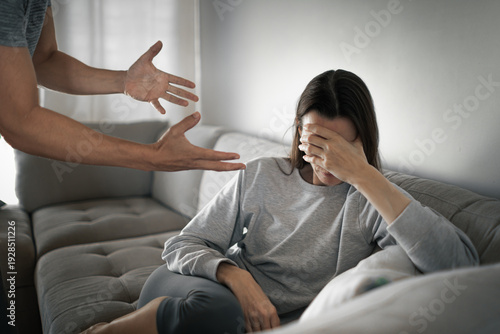 Photos angry man shouting at upset woman on couch, domestic conflict and emotional abus