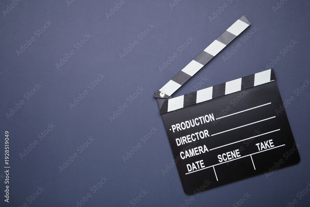 Naklejka premium One movie clapper on dark blue background. Film industry