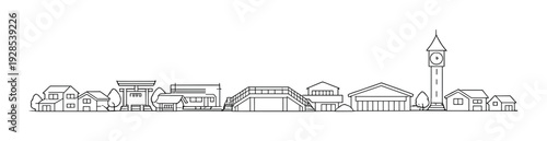 Small town houses and clock tower with arched pedestrian bridge