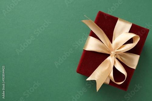 Beautiful velvet gift box on green background, top view. Space for text