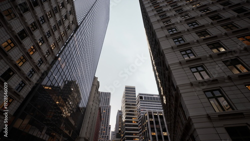 Wallpaper Mural overcast city street framed by towers, stacked modern tower punctuates skyline, mixed brick and glass facades contrast texture, muted daylight softens Torontodigital.ca