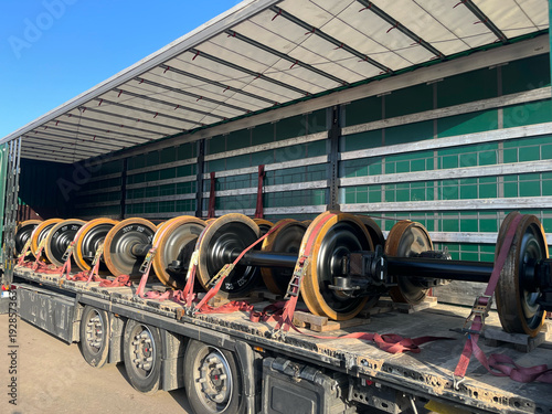 Transportation of Railway Wheelsets in a Semi-Trailer Truck — Steel Axles Delivery on Flatbed Trailer