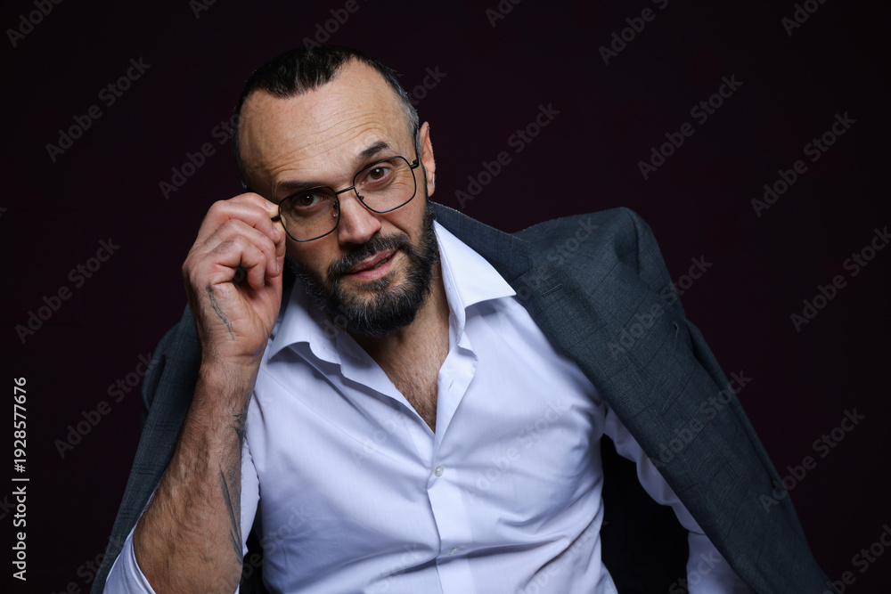 Obraz premium Fashion model. Handsome man with jacket on black background