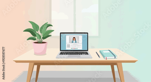 Modern workspace with laptop, plant, and notepad on wooden desk  