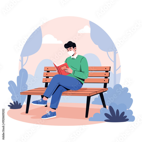 Man sitting on a bench reading a book in a park