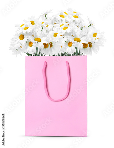 Bouquet of flowers in paper bag on white background. Romantic gift