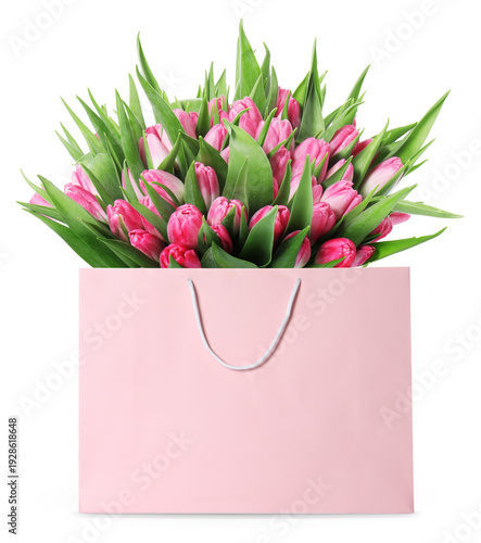 Pink tulips in paper bag on white background. Romantic gift