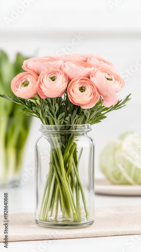 Elegant ranunculus bloom in vintage glass vase for home decor and floral arrangement